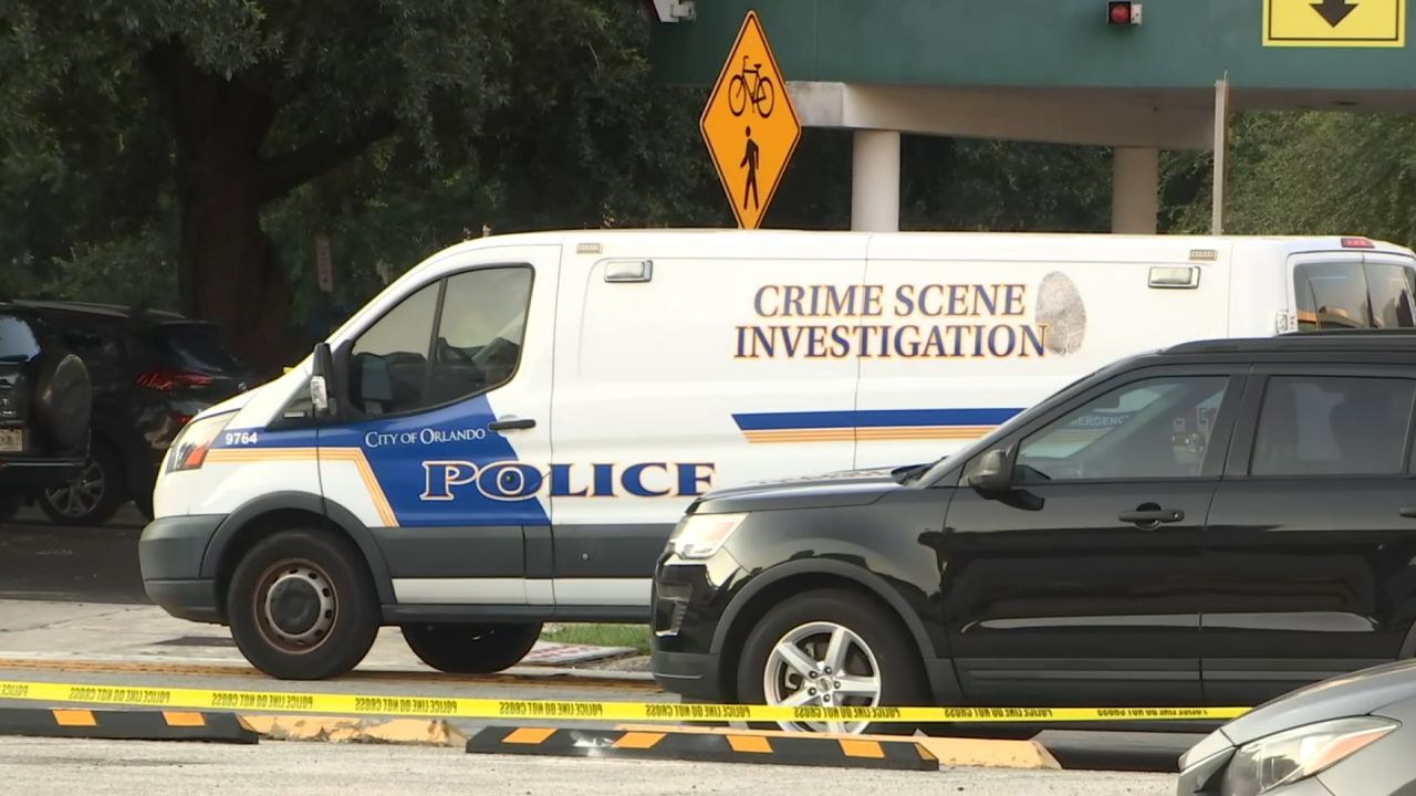 Investigators work at the scene of a shooting that injured two Orlando, Florida, officers.