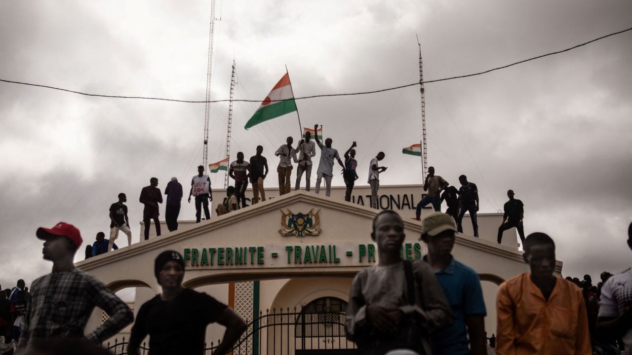 Protesters hold a Niger flag during a demonstration on Thursday.