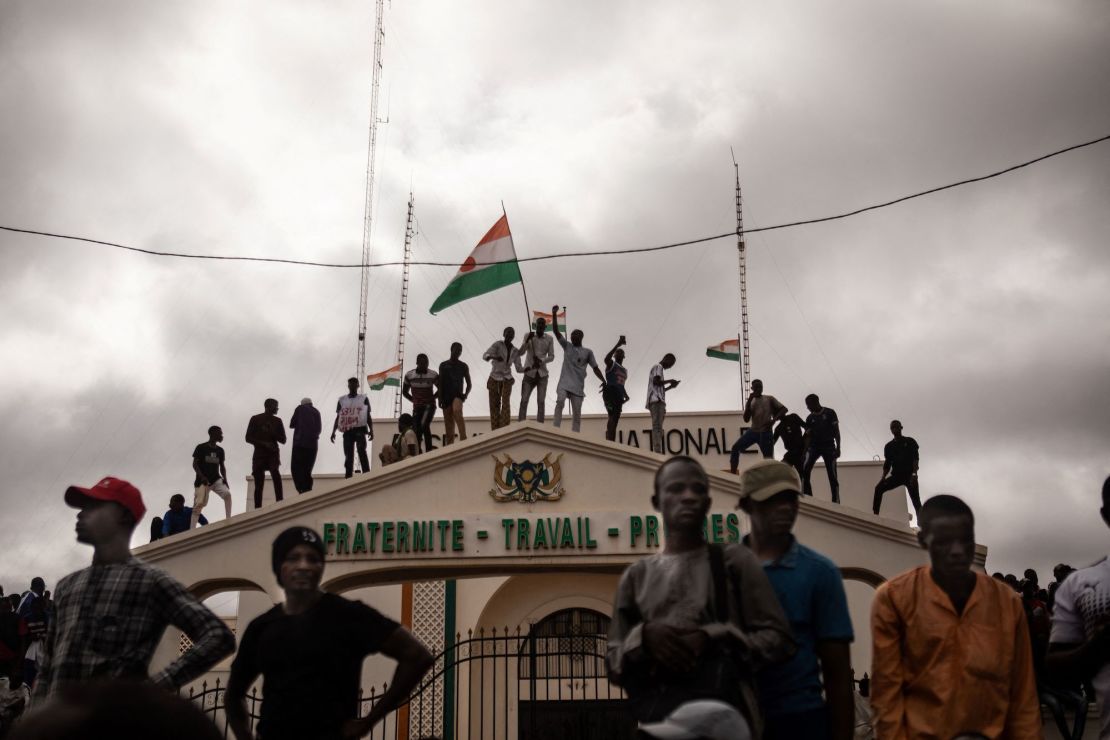 Pro-coup protesters hold the Nigerien flag during a demonstration on independence day in Niamey on August 3, 2023. 