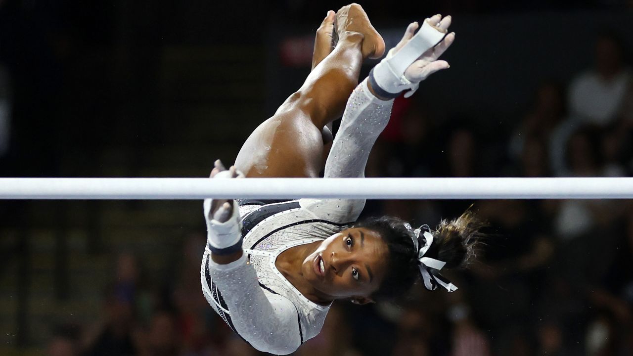 HOFFMAN ESTATES, ILLINOIS - AUGUST 05: Simone Biles competes in the uneven bars during the Core Hydration Classic at Now Arena on August 05, 2023 in Hoffman Estates, Illinois. (Photo by Stacy Revere/Getty Images)