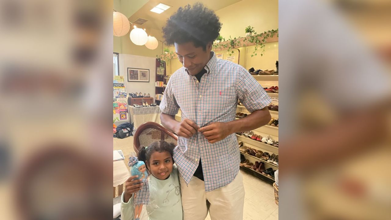 A father wears a shirt from Team TLC NYC's Little Shop of Kindness as his daughter holds a Barbie wearing a dress of the same fabric. Lakin made both.