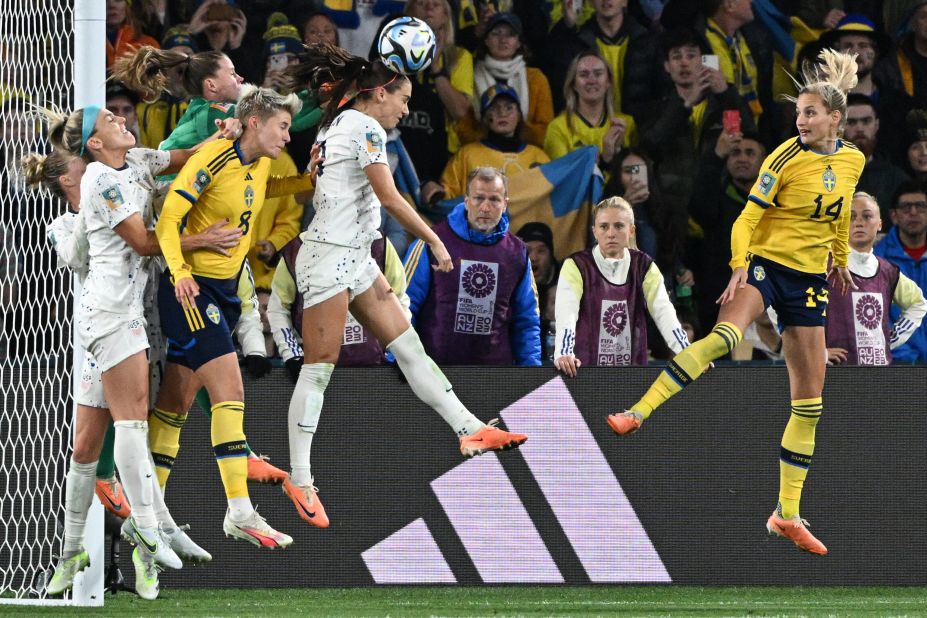 USA's forward Alex Morgan, center, heads the ball against Sweden.