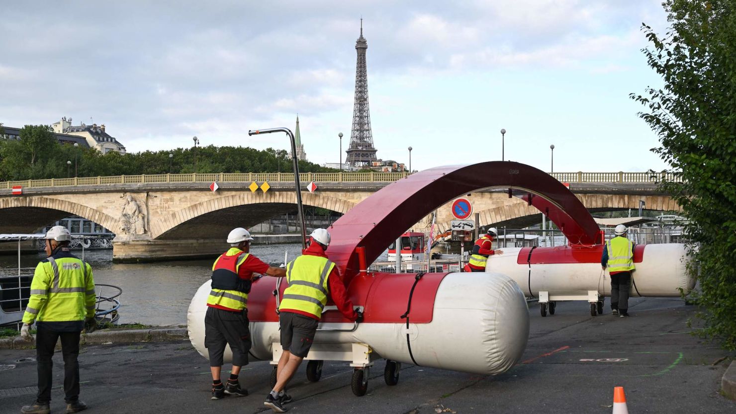 Workers are seen dismantling a temporary venue to host a pre-Olympic swimming test competition that was canceled on Sunday.