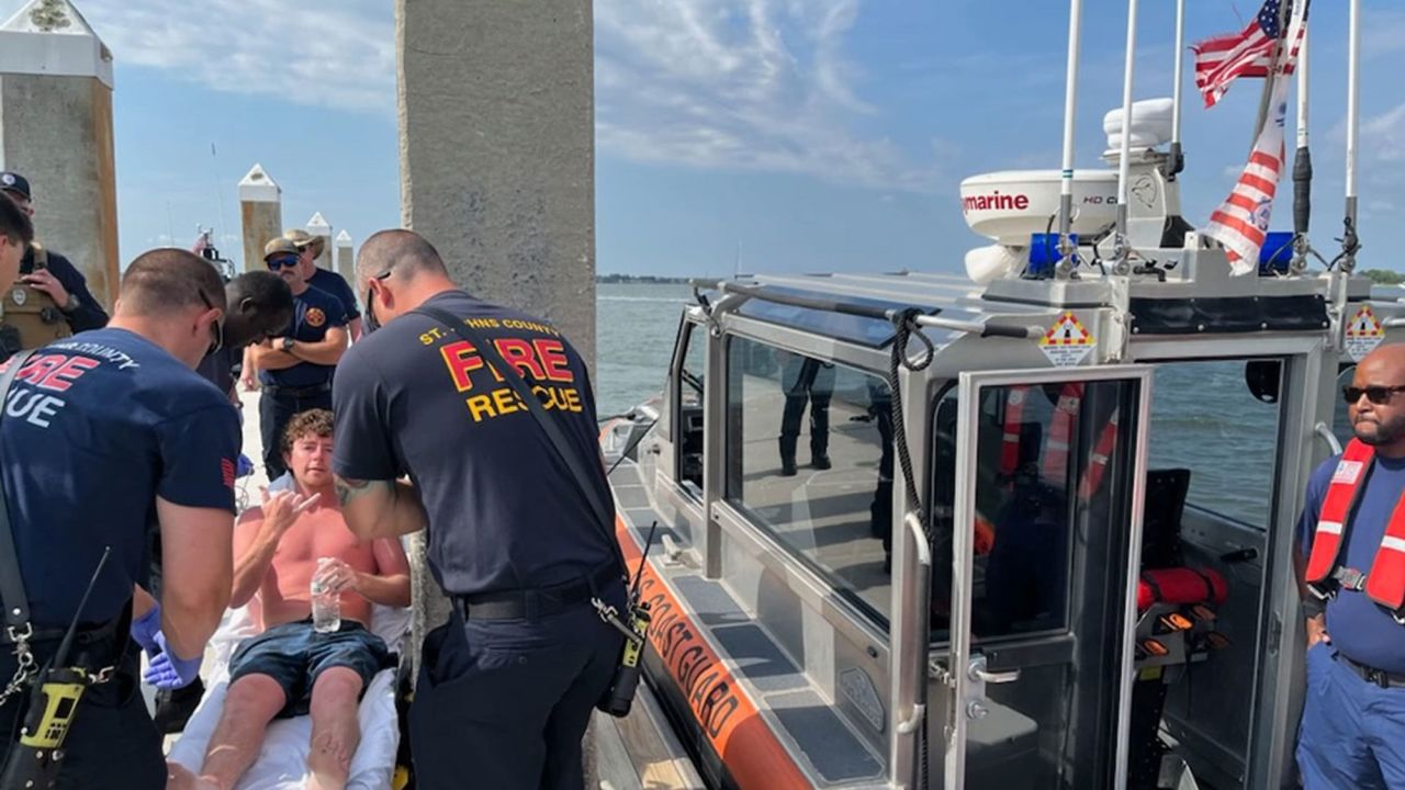Charles Gregory receives care from EMS after being rescued a dozen miles off Florida's coast on Saturday.