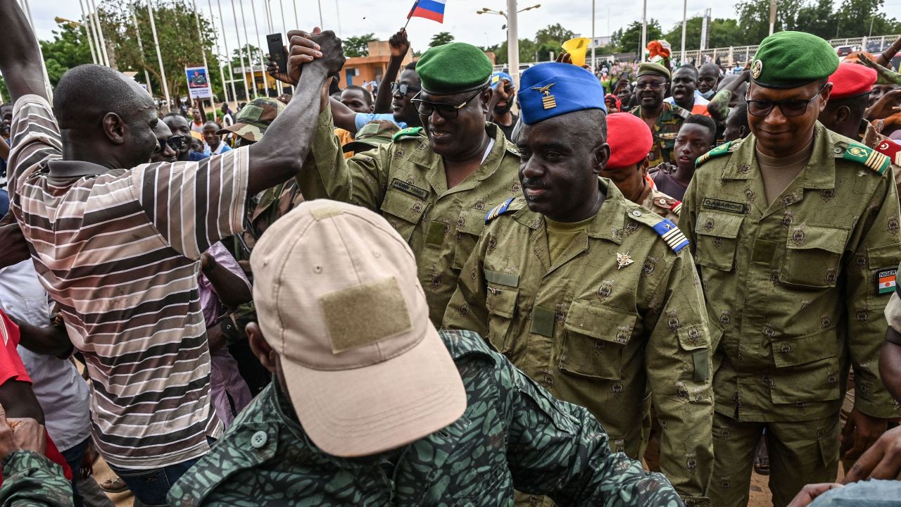 Niger's National Council for the Safeguard of the Homeland Colonel-Major Amadou Abdramane, center, is greeted by supporters as he arrives at the Stade General Seyni Kountche in Niamey, Niger, on August 6, 2023.