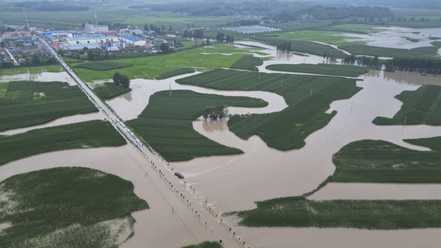 Fields and roads in the city of Shulan in northeastern China's Jilin province are submerged by floodwater on August 4.