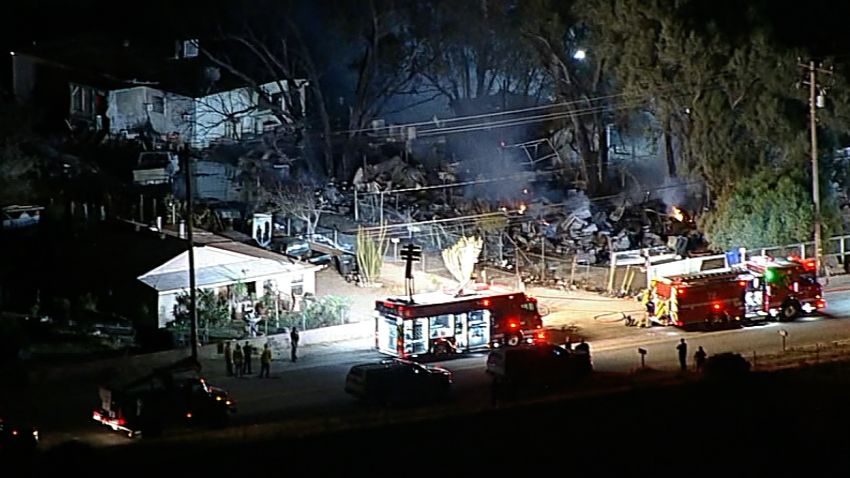 Night aerials shot by affiliate KABC of a firefighting chopper crash scene in Riverside County, several EMS on scene, emergency lights, caution tape surrounding a certain area, close and wide shots of the active scene