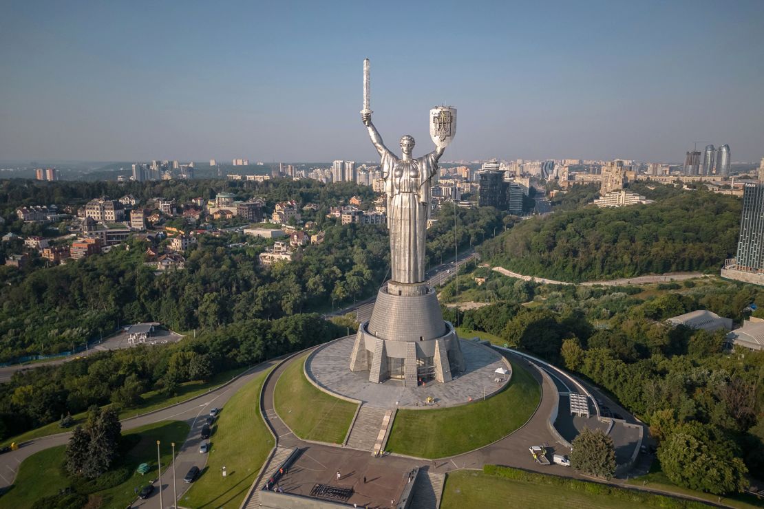 The steel statue, pictured with the Ukrainian coat of arms on Sunday, is an imposing feature of Kyiv's skyline. 