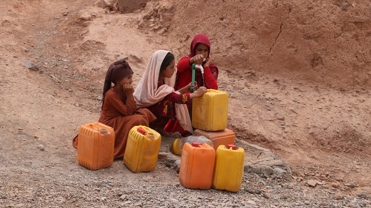 Girls fetch water from a public tap amid hot weather in Farah Province, Afghanistan, July 26, 2023.