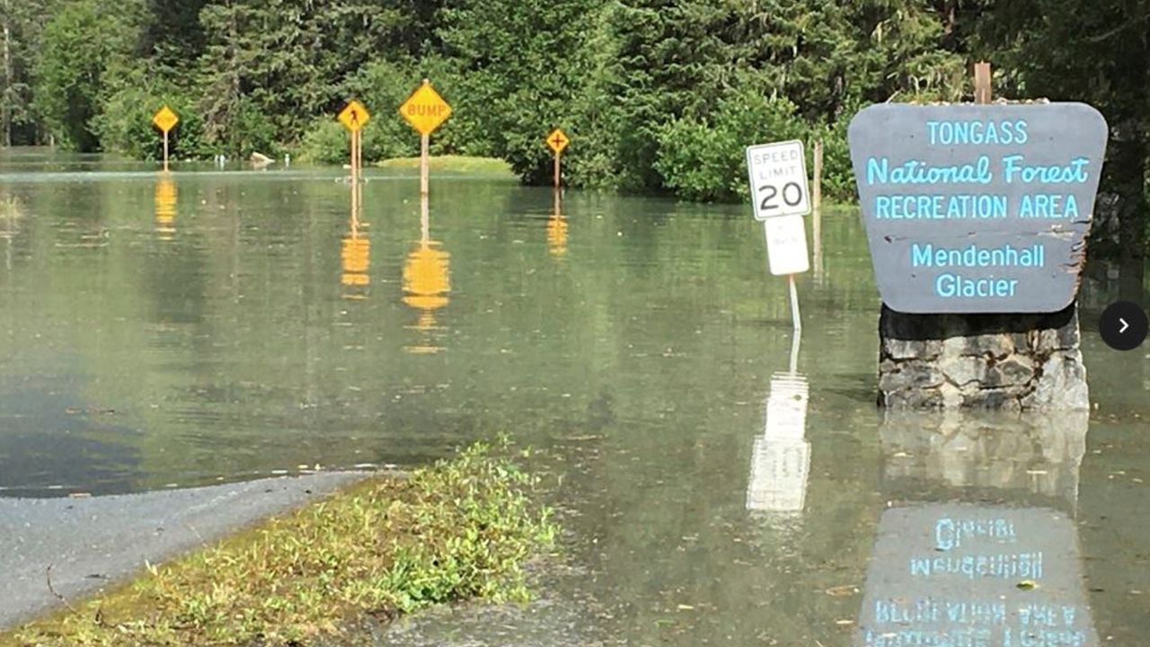 Water inundates a roadway in the Tongass National Forest in Juneau, Alaska, after a glacier basin outburst caused major flooding in the area.