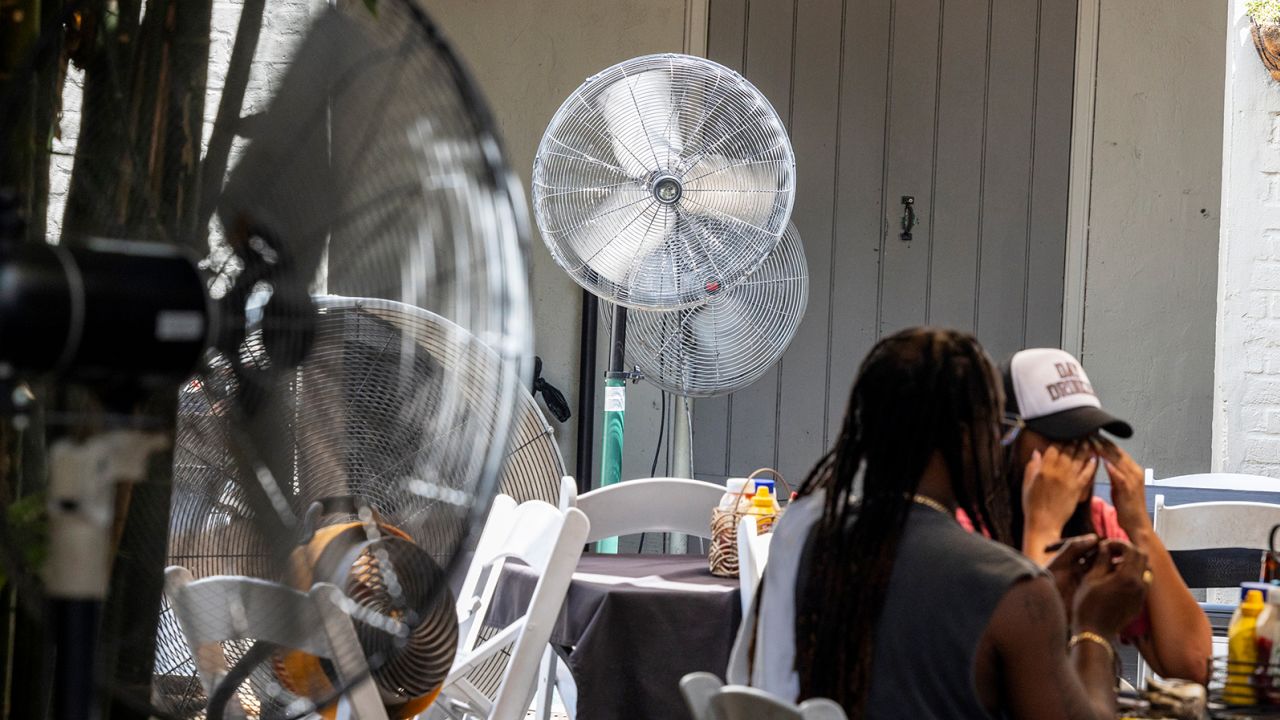 Fans are placed around the courtyard of Club Bourbon Heat during a record heatwave in the French Quarter of New Orleans on Monday, July 31, 2023.