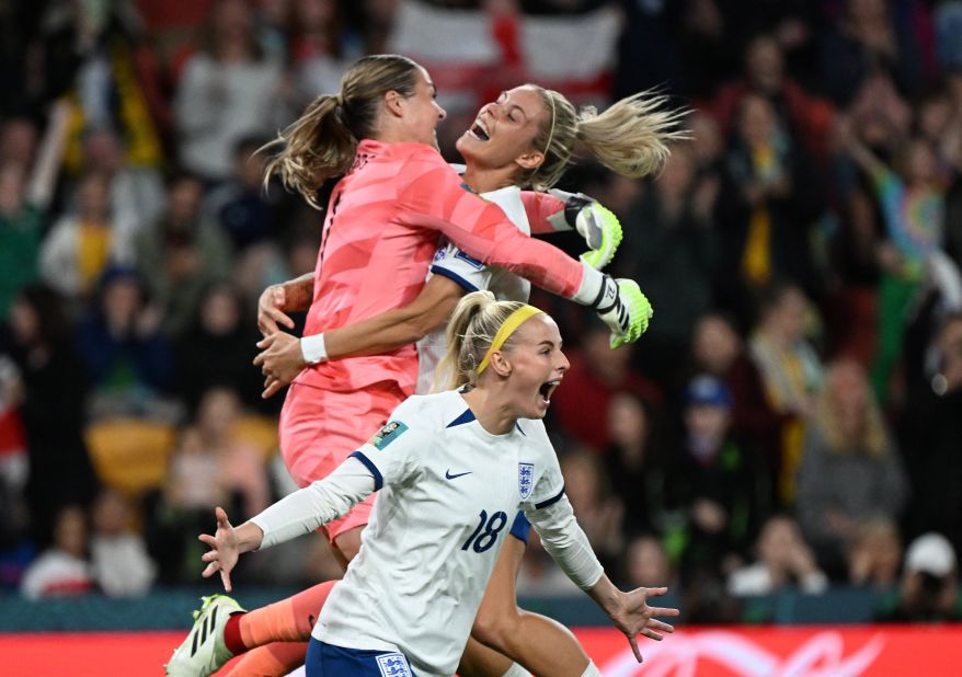 England's Chloe Kelly, center, celebrates as teammates Rachel Daly and goalkeeper Mary Earps after scoring her team's fifth and winning penalty in a shootout during the match between England and Nigeria, at Brisbane Stadium in Brisbane, Australia, on Monday, August 7. England goes through to the quarterfinals <a href=