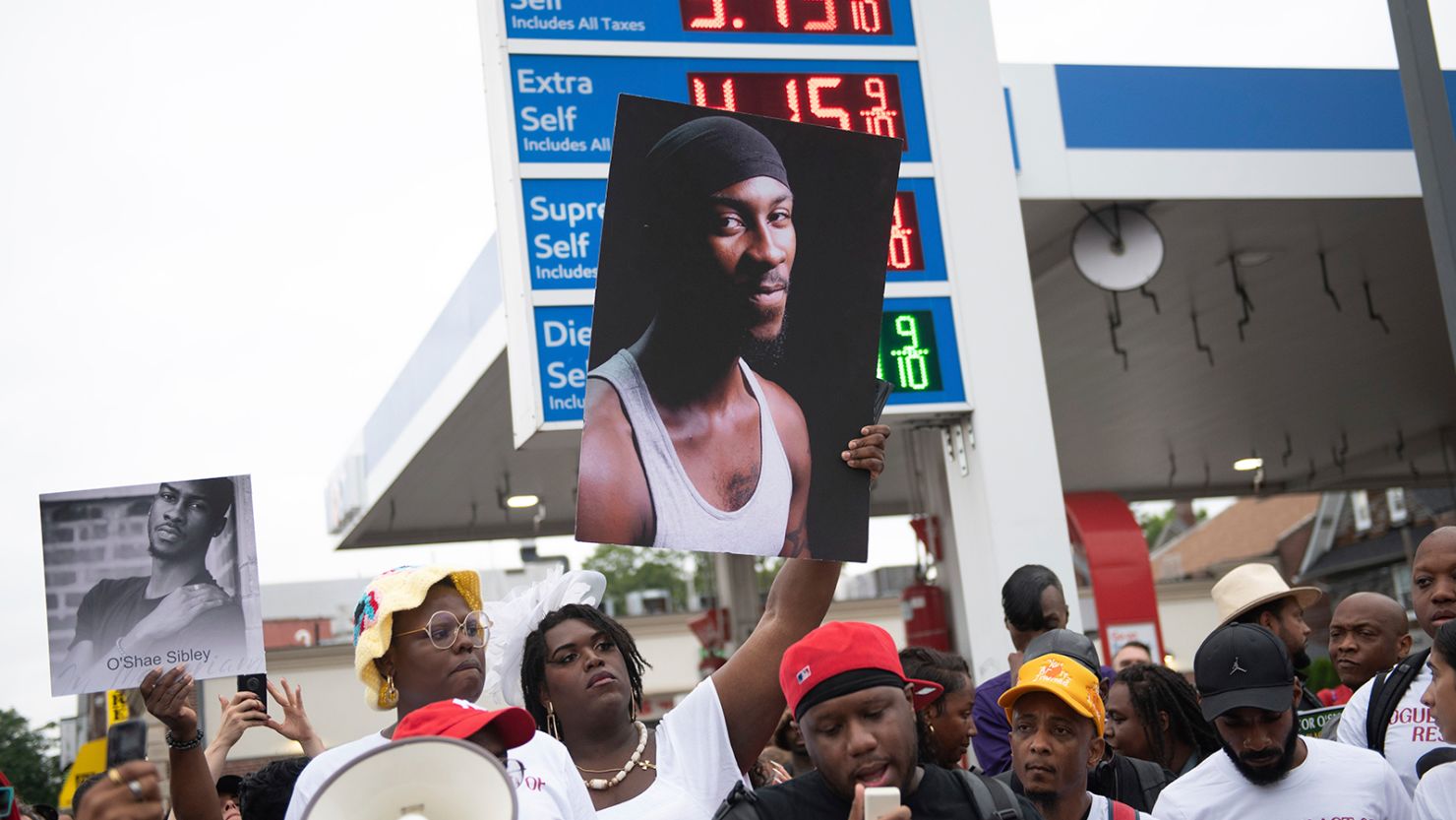 People gather at a Brooklyn, New York, gas station during a vigil to memorialize O'Shae Sibley on Friday, August 4, 2023. 