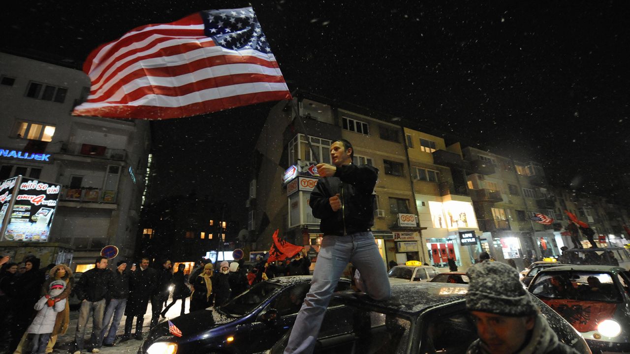 A Kosovar local waves a US flag as thousands celebrated the announcement of the independence of Kosovo, in February 2008.