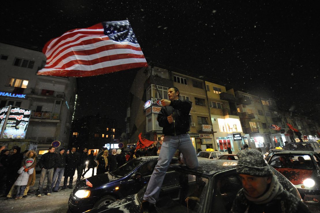 A Kosovar local waves a US flag as  thousands celebrated the announcement of the independence of Kosovo, in February 2008.
