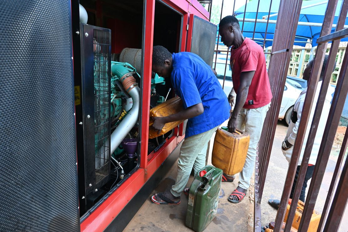 Men pour diesel from jerrycans to a generator in Niamey on Monday.