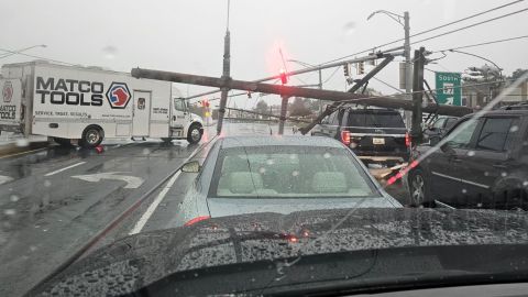 A driver was stuck in car after downed electrical poles crashed on vehicles in Westminster, Maryland on Monday.