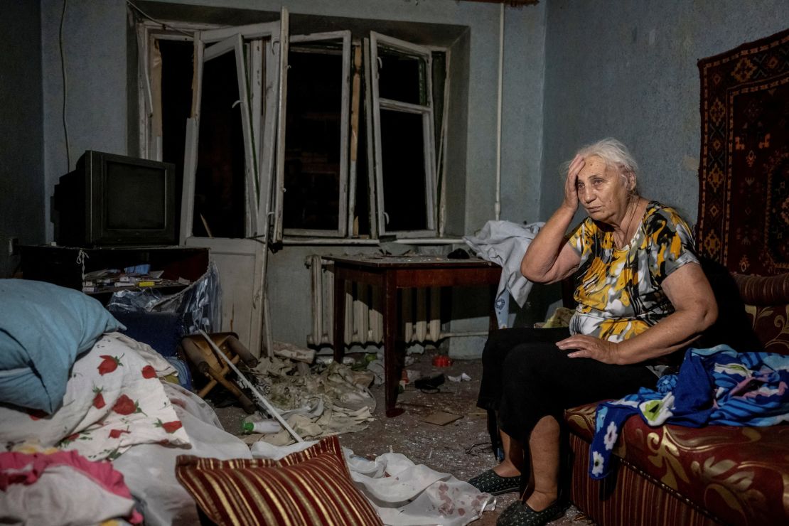 A wounded local resident is seen in her destroyed flat after the strikes in Pokrovsk.