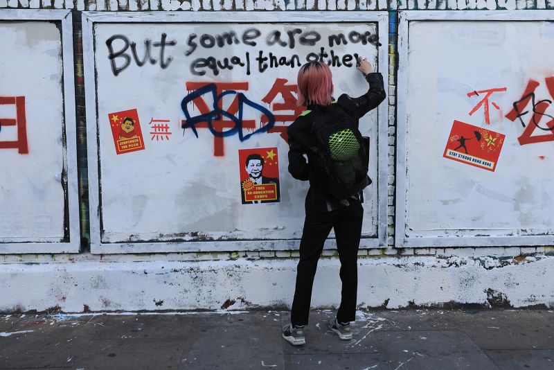 Chinese propaganda slogans turn London's Brick Lane into a protest