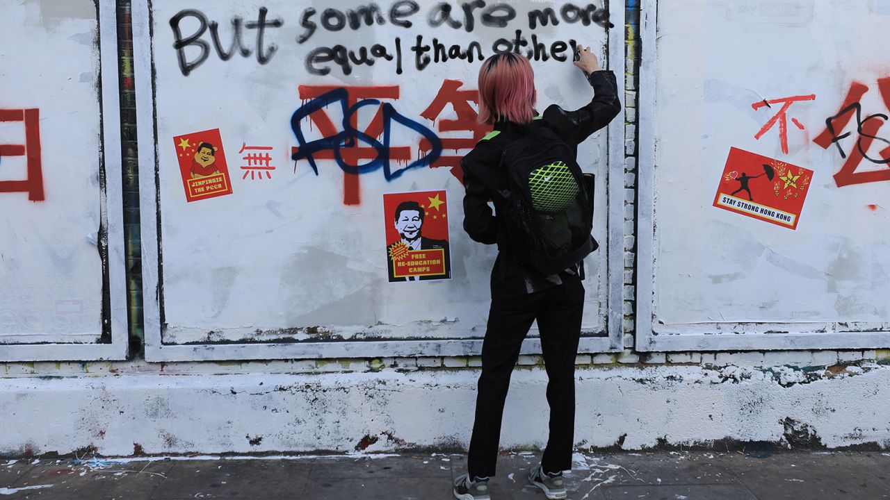 A slogan promoting China's socialist ideology in London's Brick Lane has sparked a flurry of graffiti decrying the authoritarian rule of the Chinese Communist Party.