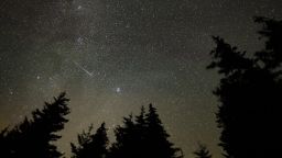 In this 30 second exposure, a meteor streaks across the sky during the annual Perseid meteor shower, Wednesday, Aug. 11, 2021, in Spruce Knob, West Virginia.