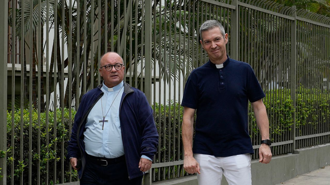 Vatican investigators, Archbishop Charles Scicluna, from Malta, left, and Monsignor Jordi Bertomeu, from Spain, walk outside of the Nunciatura Apostolica during a break from meeting with people who allege abuse by the Catholic lay group Sodalitium Christianae Vitae (SCV) in Lima, Peru, Tuesday, July 25, 2023. The investigators began an audit of the SCV with interrogations of its representatives, alleged victims and journalists who have investigated charges against the brotherhood of alleged sexual abuse and financial corruption. (AP Photo/Martin Mejia)