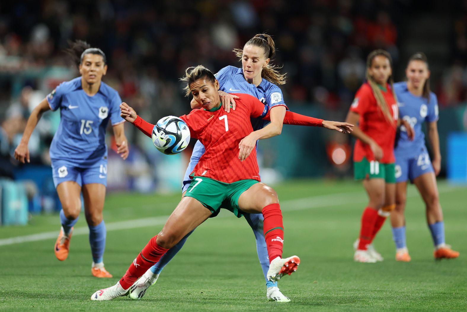 Morocco's Ghizlane Chebbak and France's Sandie Toletti compete for the ball. 