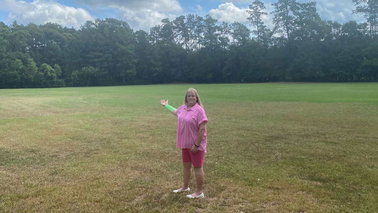 Peggy Jones stands at the 6-acre property where she was attacked July 25 by a hawk and snake.