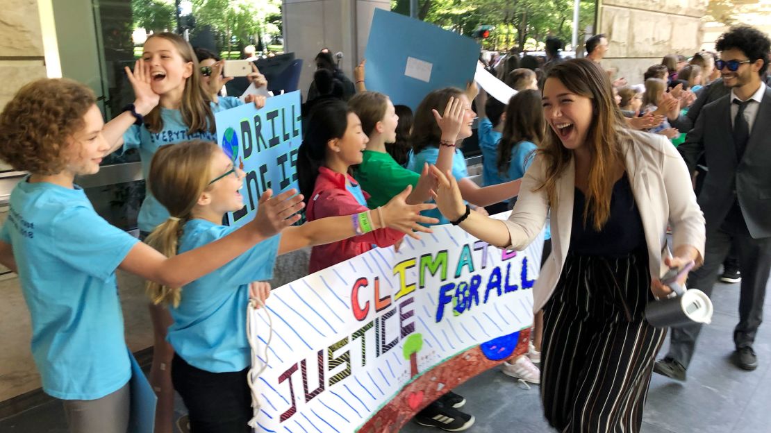 Kelsey Juliana of Eugene, Oregon, one of Juliana's lead plaintiffs, greets supporters outside a federal courthouse in Portland in 2019.