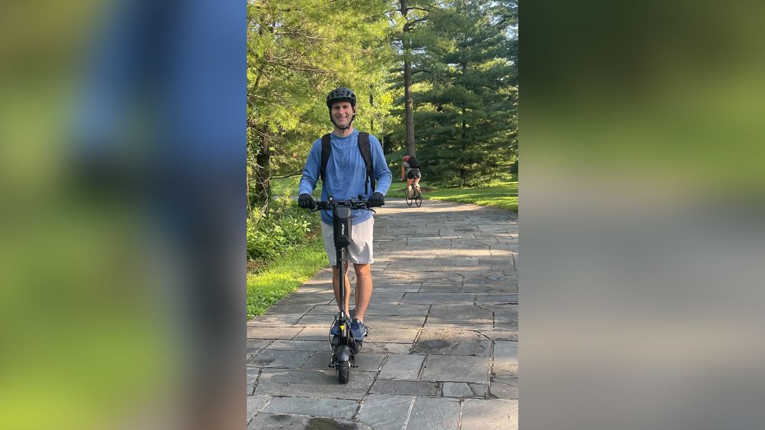 Hunter Scott rides his scooter to work in the Washington, DC, area. Scott commutes 12 miles to work every day via scooter to reduce his vehicle costs. 