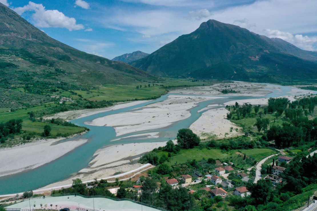 An aerial photograph taken on May 6, 2021, shows the Vjosa River, near the city of Tepelena. - The Vjosa River in Albania is one of the last remaining wild rivers in Europe with a rich and diverse habitat. For years environmentalists in Albania and abroad have rallied to prevent projects to build dams in the river, asking the government of Albania to grant the river the full legal protection of a National Park. The Albanian government has granted the inferior status of protected area only to a part of the river flow, but environmentalists insist on establishing Vjosa Wild River National Park  which guarantees protection to the full length of the Vjosa and its free-flowing tributaries from future exploitations to build dams. (Photo by Gent SHKULLAKU / AFP) (Photo by GENT SHKULLAKU/AFP via Getty Images)