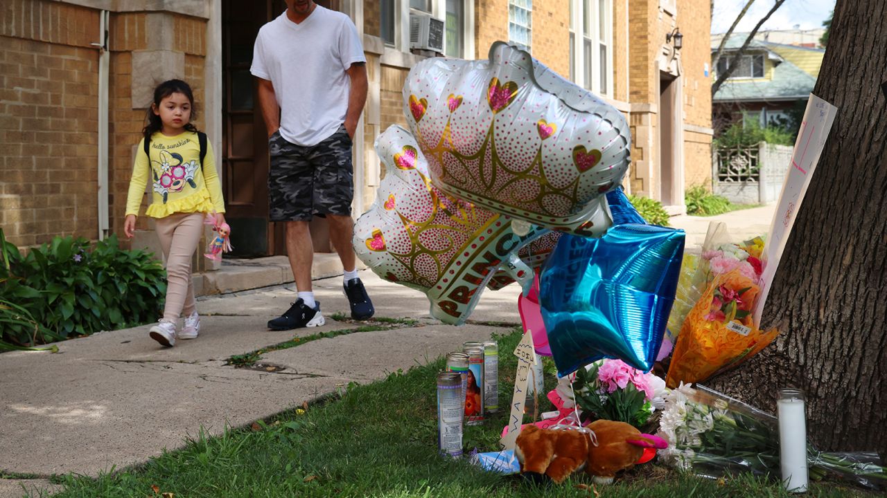 Neighbors pass by a memorial for a 9 year-old girl shot and killed outside of her Portage Park apartment on Saturday, on Monday, Aug. 7, 2023, in Chicago. (Stacey Wescott/Chicago Tribune/Tribune News Service via Getty Images)