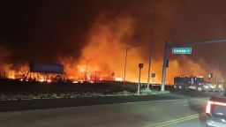 Flames are seen at the intersection of Hokiokio Place and Lahaina Bypass in Maui, Hawaii, on Tuesday night.