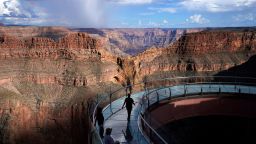 People walk across the Grand Canyon Skywalk on Hualapai reservation Tuesday, Aug. 16, 2022, in northwestern Arizona. 