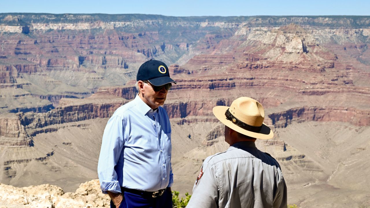 President Joe Biden speaks to Ed Keable, superintendent of Grand Canyon National Park, while looking over the Grand Canyon at the Yaki Point lookout in Arizona on August 8, 2023. 