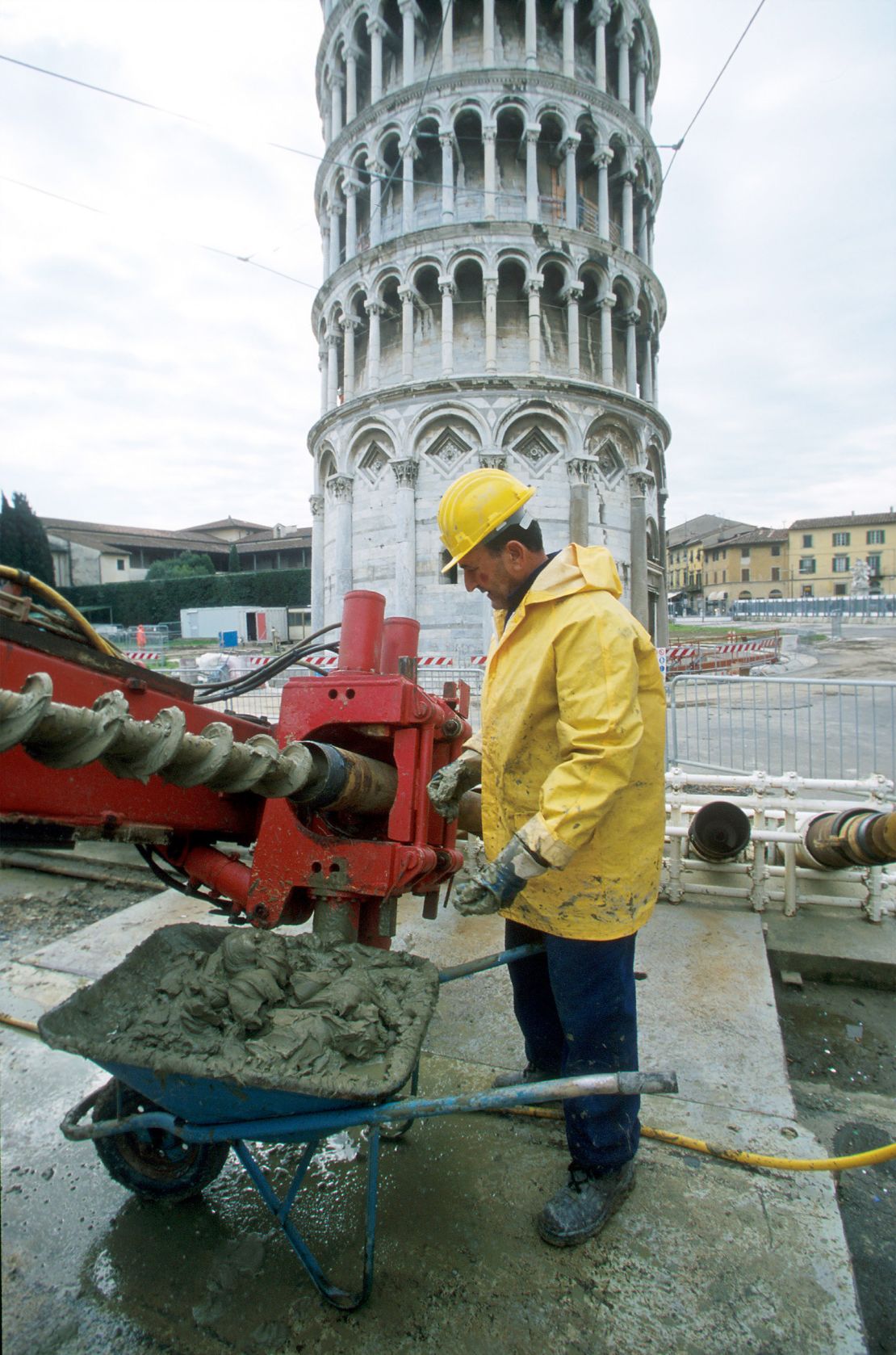 386905 12: A worker takes mud off a special giant drill March 31, 2001 in Pisa, Italy. The drill is making one of 41 holes or perforations into the earth on the north side of the Leaning Tower of Pisa March 2001 in Pisa, Italy to decrease its incline, which tilts south. The Tower, completed in 1370, has been under restoration to secure its foundation and hence closed to visitors since 1990. The restoration will decrease the angle of the tower's incline by 1/2 degree, bringing it back to the position it held 3 centuries ago. It is scheduled to re-open June 16, 2001. (Photo by Giulio Andreini/Liaison)