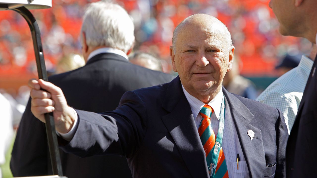 In this 2012 photo, H. Wayne Huizenga stands on the field before an NFL football game between the Miami Dolphins and New York Jets in Miami.
