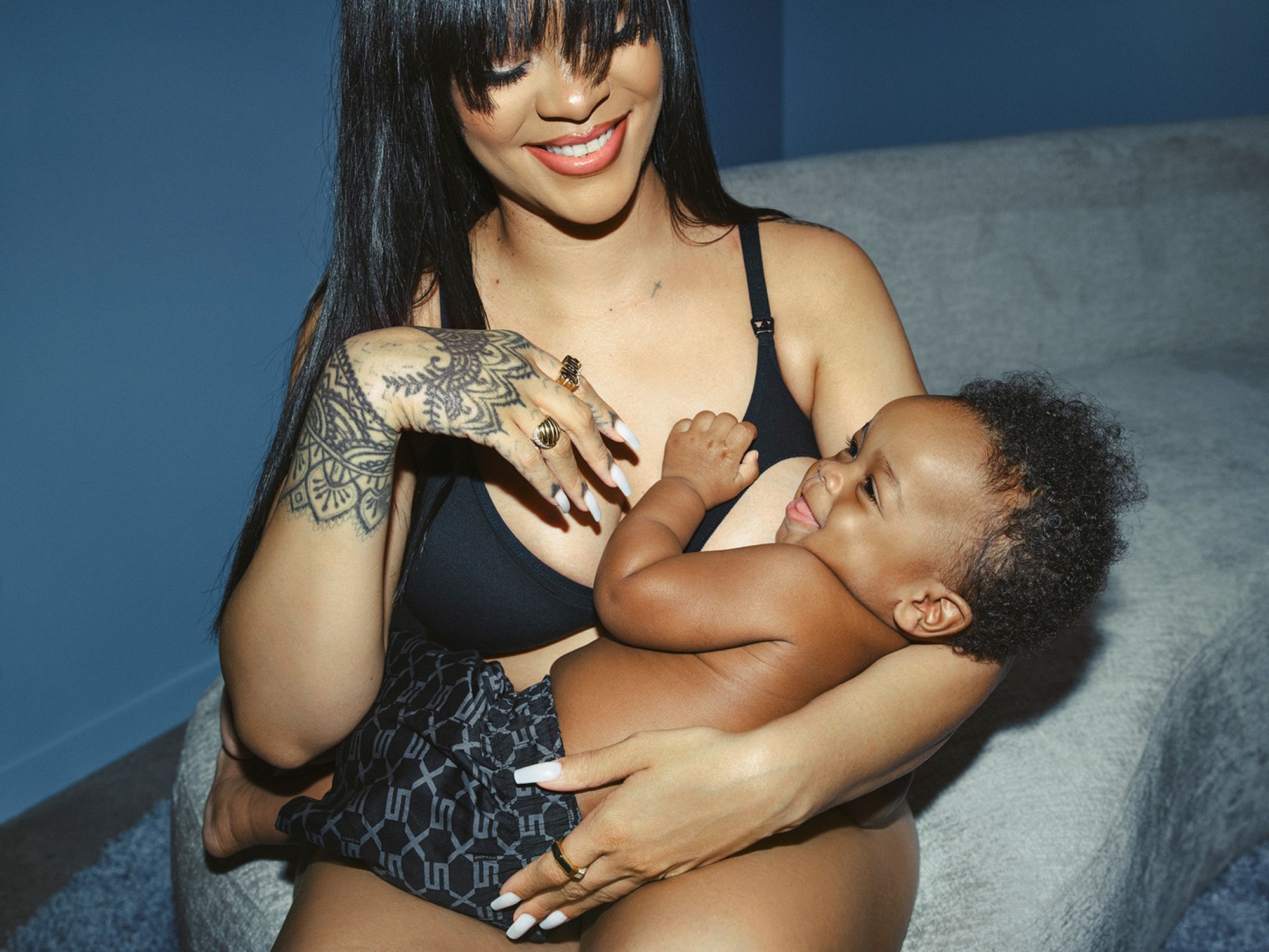 Rihanna, holding her son RZA, wears the Savage X Cotton Maternity Bralette in the color Black Caviar.
