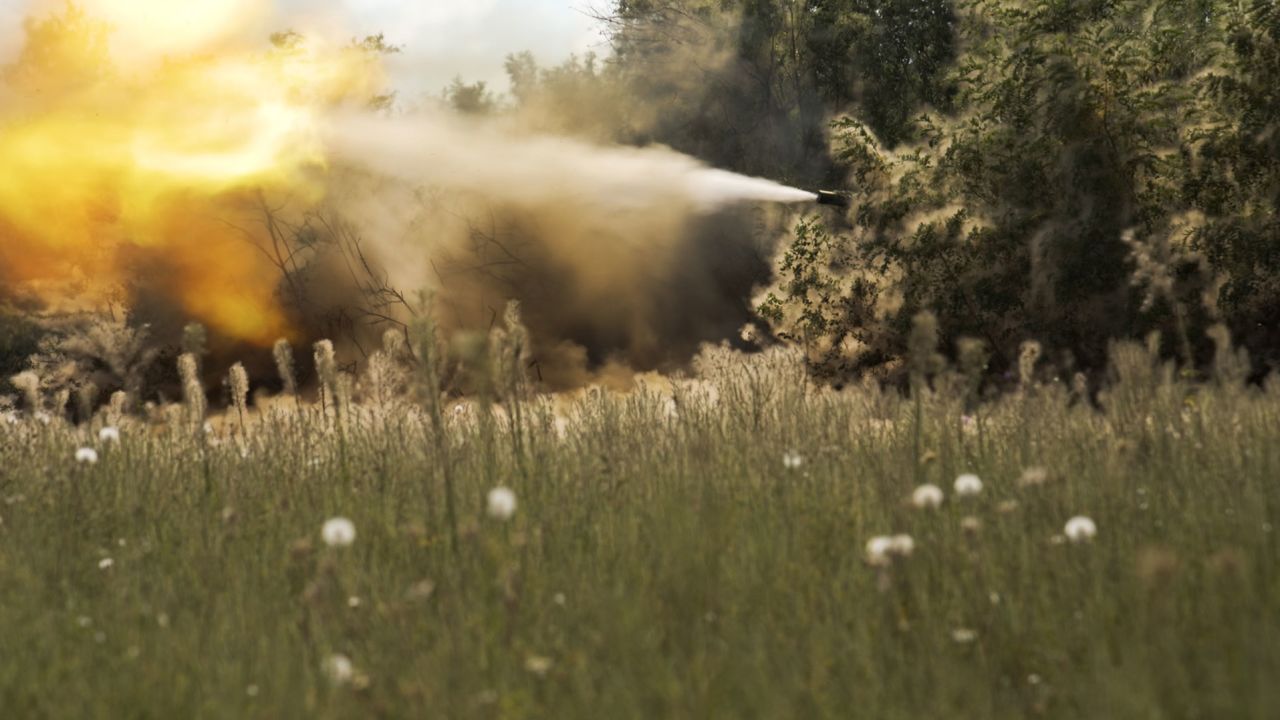 A Ukrainian tank fires from a treeline towards Russian forces on the country's southern frontline.