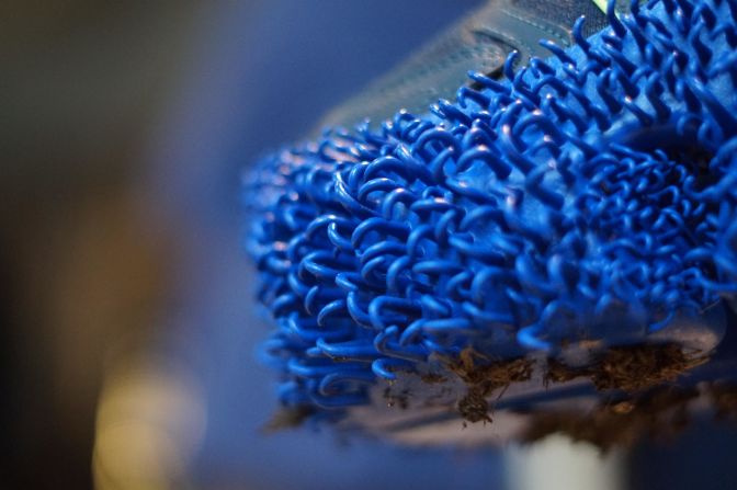 A close-up of the outsole shows the small loops that function as hooks. Inspired by nature, the loops are designed to mimic how certain types of seeds hook themselves onto the fur of wild animals.