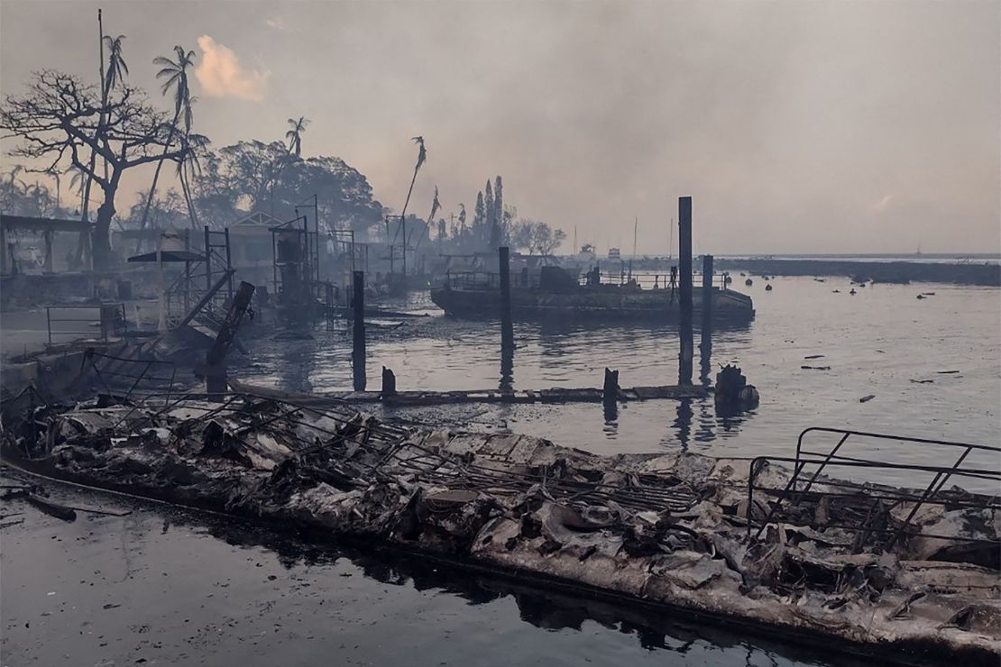 A charred boat lies in the scorched waterfront after wildfires devastated Maui's city of Lahaina on August 9, 2023.