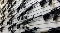 A selection of AR-15-style rifles hangs on a wall at a firearms store on Jan. 11, 2023, in Carpentersville, Illinois, a day after the state banned them.