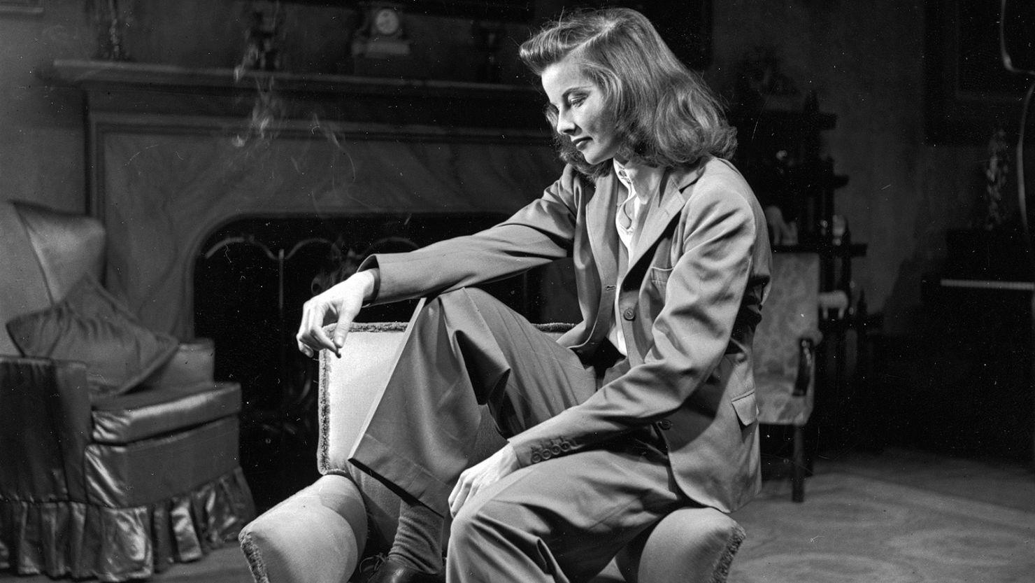 Actress Katharine Hepburn sits on the arm of a chair for a Life magazine photo shoot in 1938 in New York.