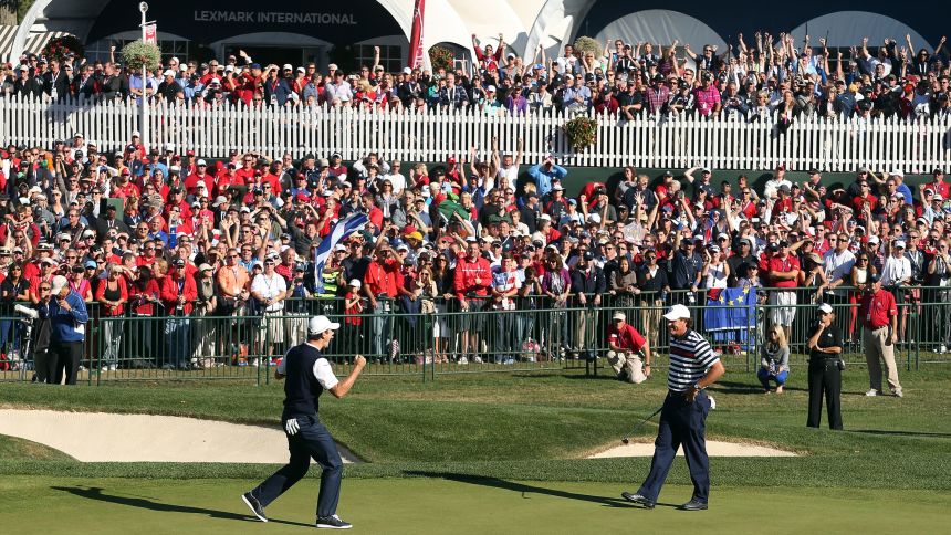 Phil Mickelson, right, walks over to congratulate Justin Rose of Europe, whose birdie putt on the 18th green defeated Mickelson during the Singles Matches for The 39th Ryder Cup at Medinah Country Club on September 30, 2012 in Medinah, Illinois.
