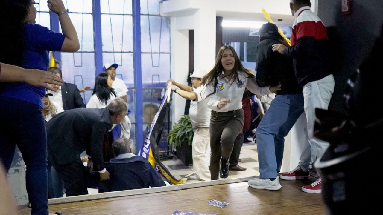 TOPSHOT - People take cover after shots were fired at the end of a rally of Ecuadorian presidential cadidate Fernando Villavicencio in Quito, on August 9, 2023. Ecuadorian presidential candidate Fernando Villavicencio was shot dead after holding a rally in Quito on Wednesday evening, local media reported, citing Interior Minister Juan Zapata. Mr. Villavicencio, a 59-year-old journalist, was one of eight candidates in the August 20 presidential election. (Photo by STRINGER / AFP) (Photo by STRINGER/AFP via Getty Images)