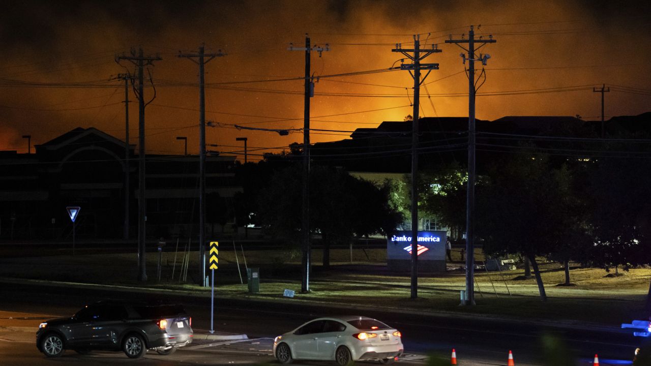 A grass fire burns in Cedar Park, Texas, on Tuesday, Aug. 8, 2023, forcing evacuations. (Sara Diggins/Austin American-Statesman via AP)