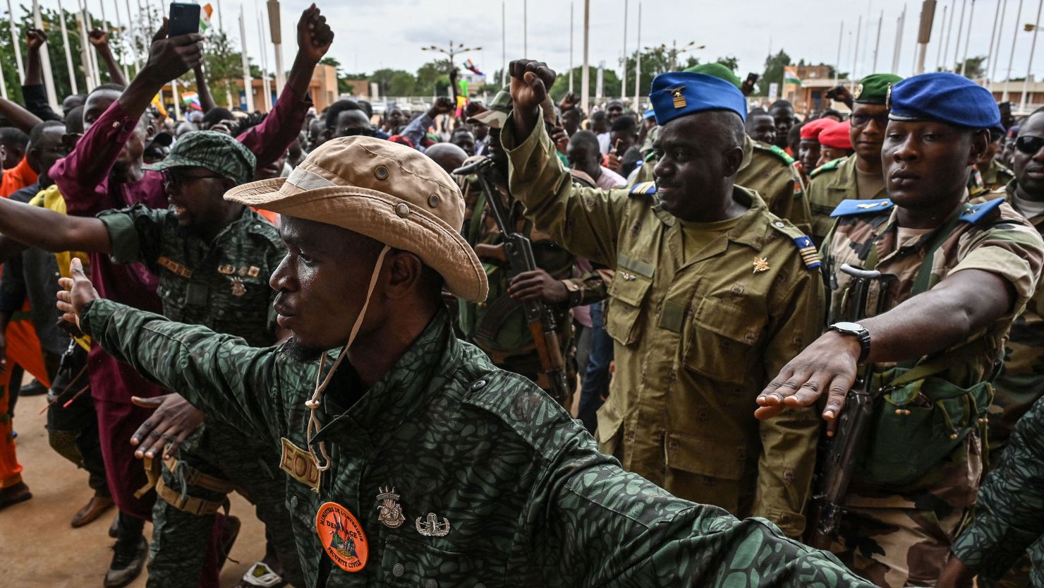 TOPSHOT - Niger's National Council for the Safeguard of the Homeland (CNSP) Colonel-Major Amadou Abdramane (2nd R) is greeted by supporters upon his arrival at the Stade General Seyni Kountche in Niamey on August 6, 2023. Thousands of supporters of the military coup in Niger gathered at a Niamey stadium Sunday, when a deadline set by the West African regional bloc ECOWAS to return the deposed President Mohamed Bazoum to power is set to expire, according to AFP journalists. A delegation of members of the ruling National Council for the Safeguard of the Homeland (CNSP) arrived at the 30,000-seat stadium to cheers from supporters, many of whom were drapped in Russian flags and portraits of CNSP leaders. (Photo by AFP) / "The erroneous mention[s] appearing in the metadata of this photo by - has been modified in AFP systems in the following manner: [Colonel-Major Amadou Abdramane] instead of [Colonel-Major Amadou Adramane]. Please immediately remove the erroneous mention[s] from all your online services and delete it (them) from your servers. If you have been authorized by AFP to distribute it (them) to third parties, please ensure that the same actions are carried out by them. Failure to promptly comply with these instructions will entail liability on your part for any continued or post notification usage. Therefore we thank you very much for all your attention and prompt action. We are sorry for the inconvenience this notification may cause and remain at your disposal for any further information you may require." (Photo by -/AFP via Getty Images)