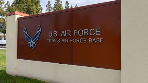 Photo of the base sign in front of the Visitor Control Center at Travis Air Force Base, California, in 2018.