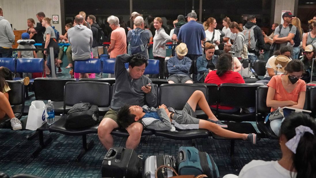 People gather at the Kahului Airport while waiting for flights in Kahului on Wednesday.