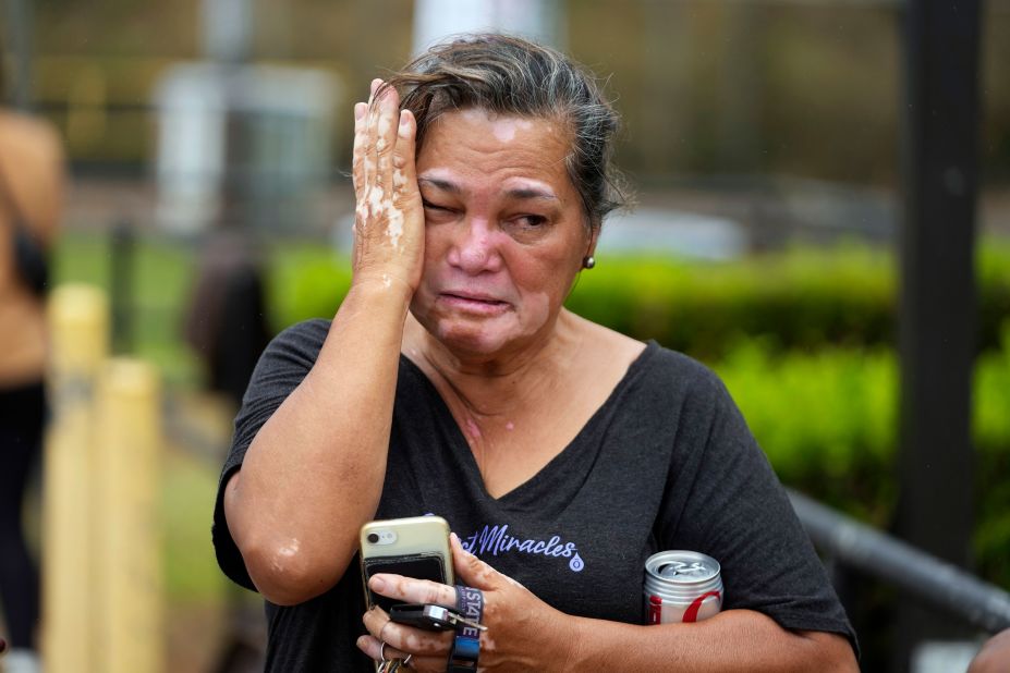 Myrna Ah Hee reacts as she waits in front of an evacuation center at the War Memorial Gymnasium on Thursday in Wailuku, Hawaii. The Ah Hees were there because they were looking for her husband's brother. Their own home in Lahaina was spared, but the homes of many of their relatives were destroyed by wildfires.